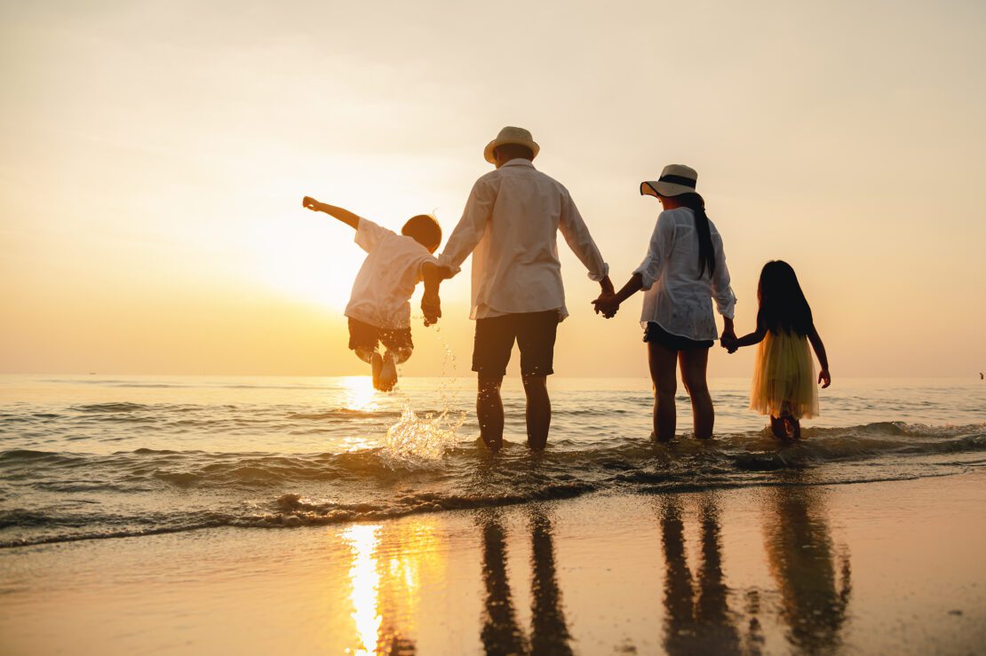 Happy,Asian,Family,Jumping,Together,On,The,Beach,In,Holiday.